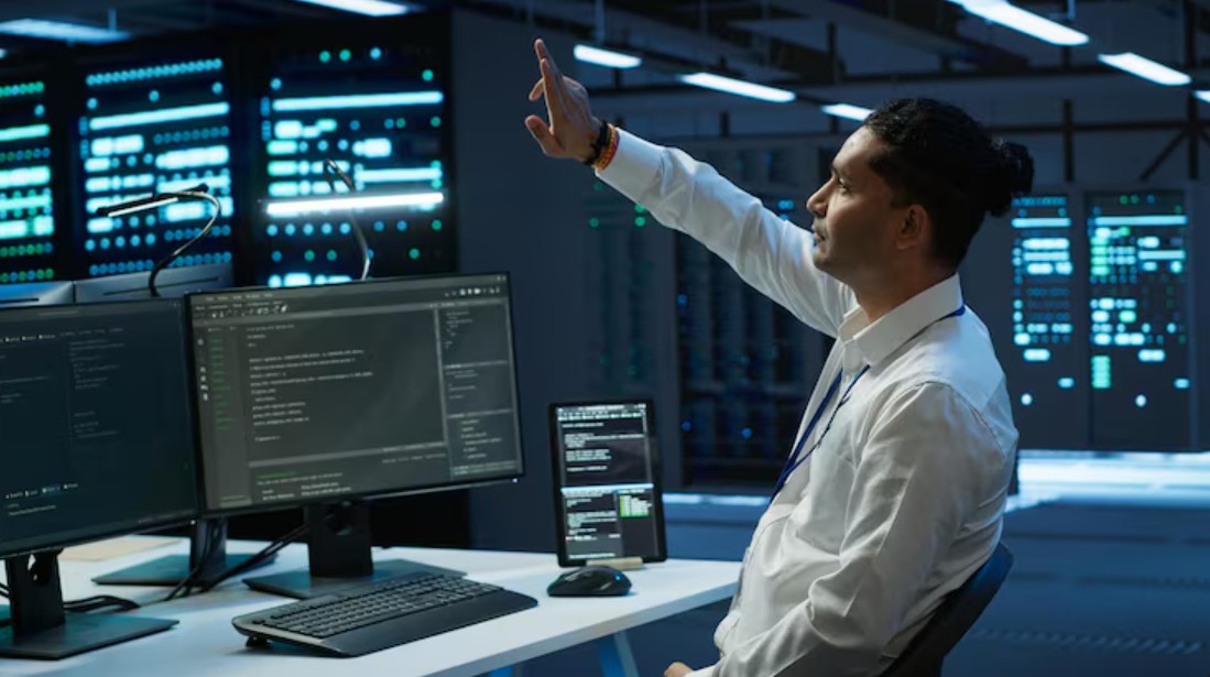 A man at a desk with dual monitors, showcasing Managed IT Services For Small Businesses in Greenville, SC, and secured IT solutions.