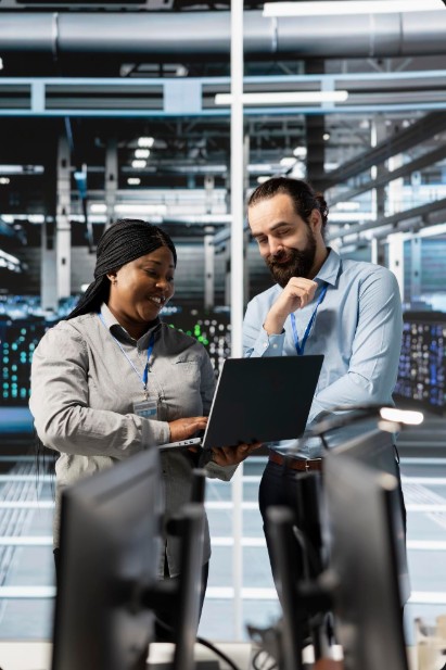 Two people discussing IT Support For Small Companies in Asheville, NC, focusing on secured cybersecurity solutions.