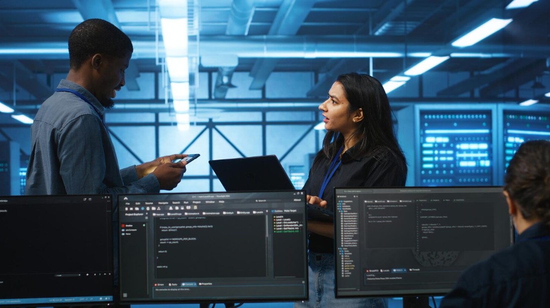 Two professionals collaborate on computers, showcasing Managed IT Services Asheville for secured IT solutions and cybersecurity.