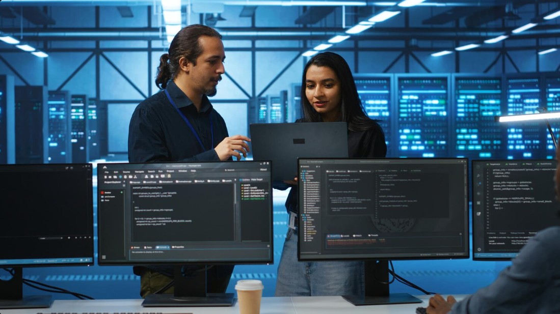 Two professionals collaborating on a computer, showcasing Managed IT Services For Small Businesses in Greenville, SC with secured IT solutions.