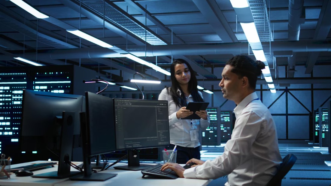 Two professionals in a data center, providing Managed IT Services For Small Businesses in Knoxville, TN with secured IT solutions.