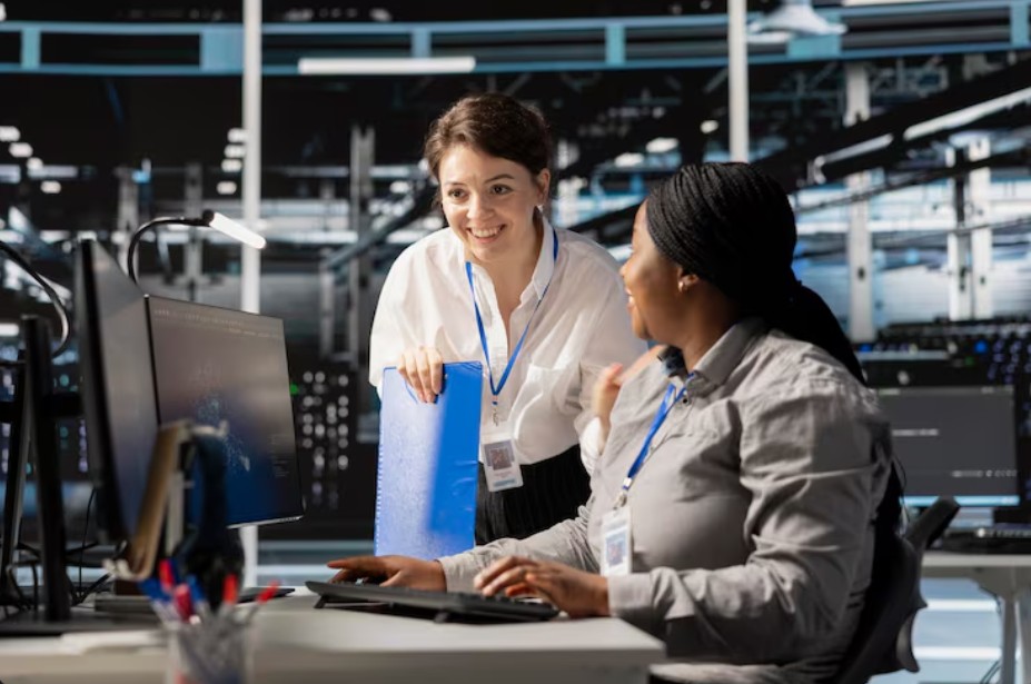 Two women collaborate on computers, providing secured Managed IT Services Asheville and effective IT solutions for cybersecurity.
